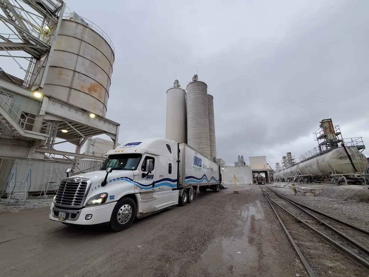 A transport truck at an industrial facility during Alex's trucking career